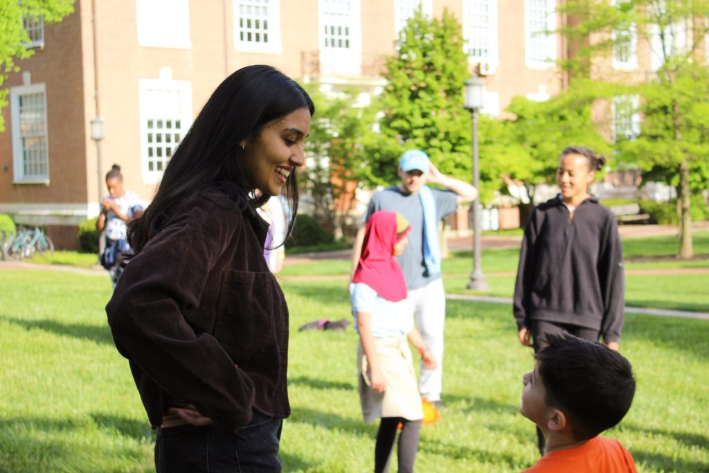 Tutor smiling talking to her tutee at the 2023 field day