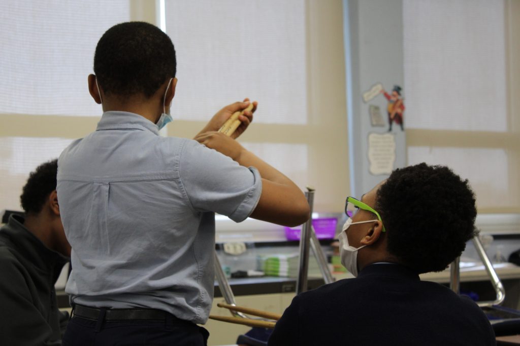 (Unedited) Students with a drumstick